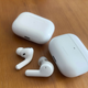 Airpods Pro case and bud next to the Amazfit Powerbuds Pro case and bud